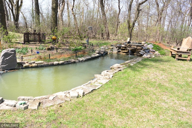 view of dock with a small pond