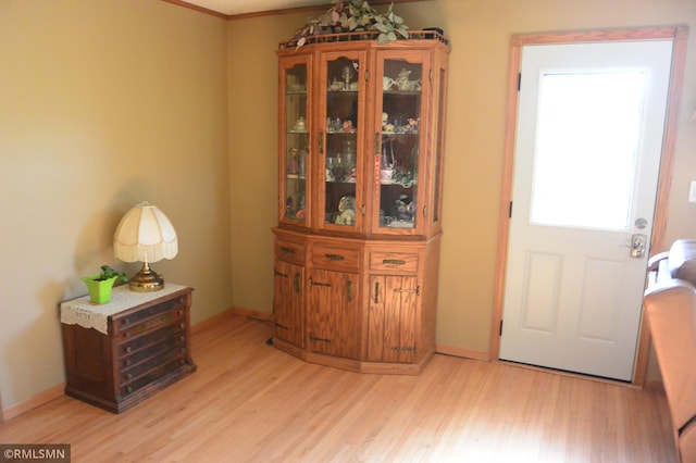 entryway with baseboards and light wood-style floors