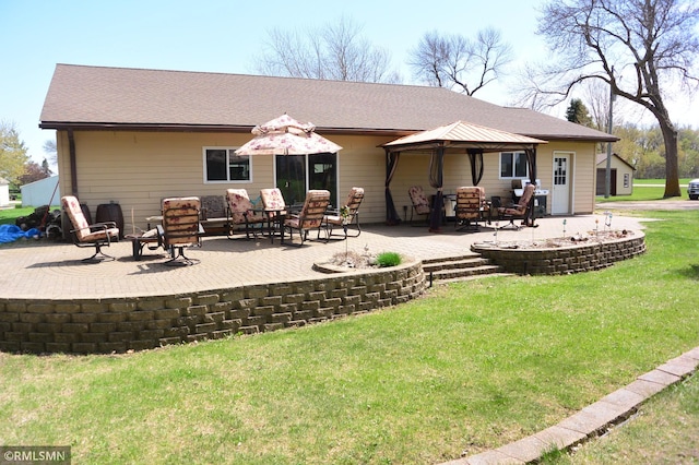 rear view of house with a lawn, a gazebo, and a patio