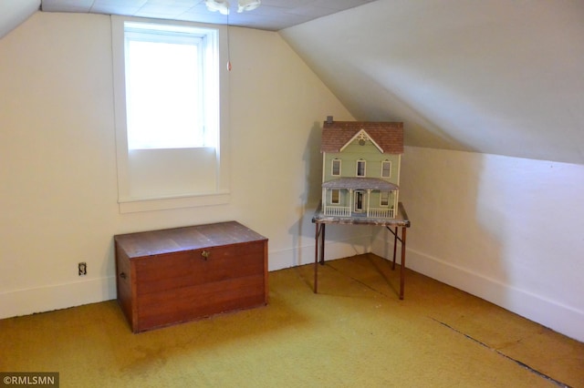 additional living space featuring baseboards, carpet flooring, and vaulted ceiling