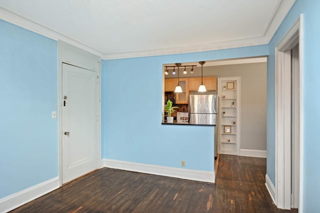 unfurnished room featuring dark wood-type flooring, baseboards, and crown molding