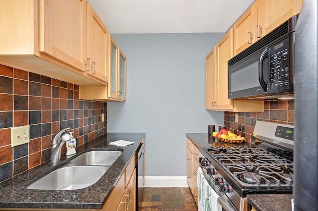 kitchen with light brown cabinets, black microwave, baseboards, stainless steel gas range, and a sink