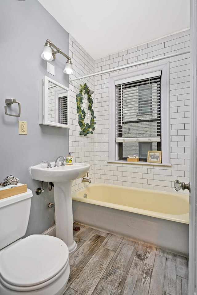 full bath featuring toilet and wood finished floors
