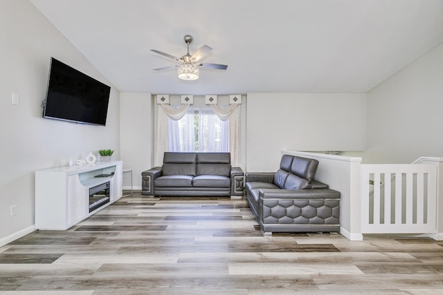 18095 Exeter Pl, Farmington, MN 55024 - living room with ceiling fan, wood finished floors, baseboards, and lofted ceiling