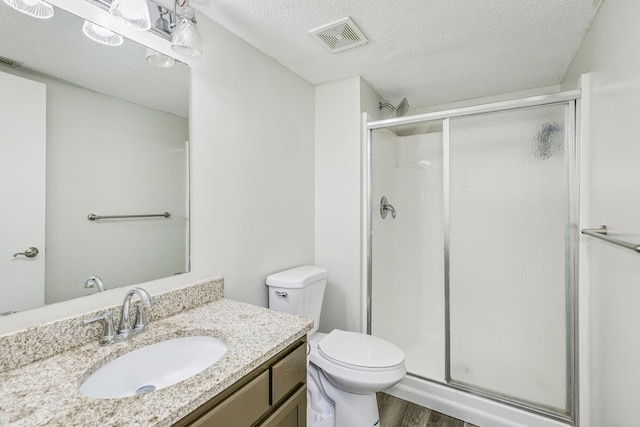 18095 Exeter Pl, Farmington, MN 55024 - full bath featuring a shower stall, vanity, wood finished floors, toilet, and a textured ceiling