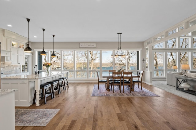 dining room with recessed lighting, light wood-style flooring, and a wealth of natural light