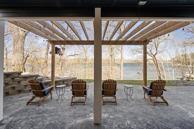view of patio with a pergola and a water view