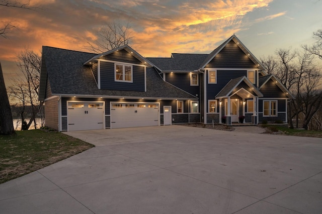 craftsman-style home featuring a garage, covered porch, concrete driveway, and roof with shingles