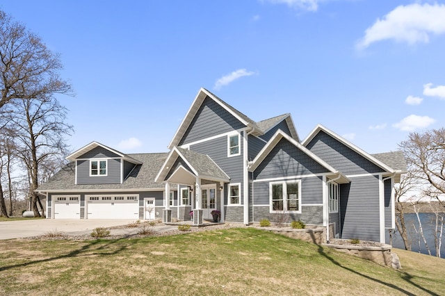 craftsman inspired home featuring an attached garage, driveway, roof with shingles, and a front lawn