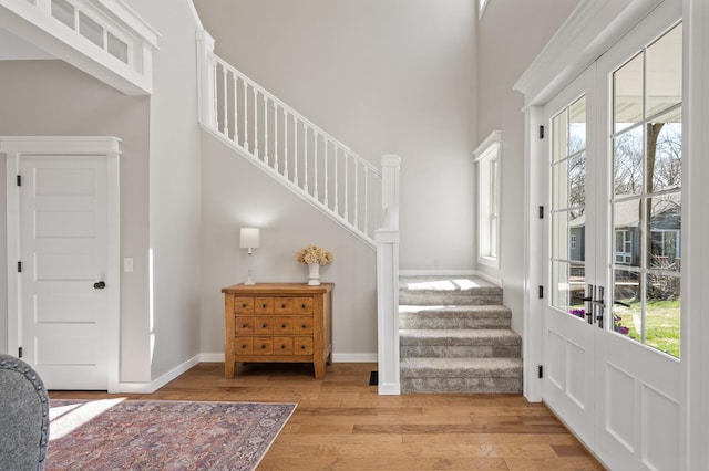 entryway with plenty of natural light, wood finished floors, and stairway