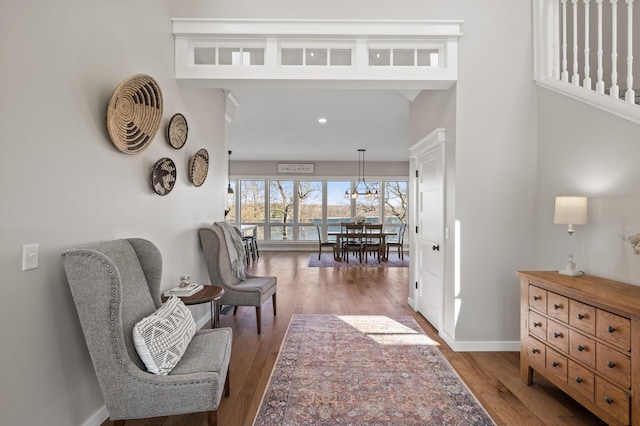 interior space featuring baseboards, recessed lighting, wood finished floors, and a chandelier
