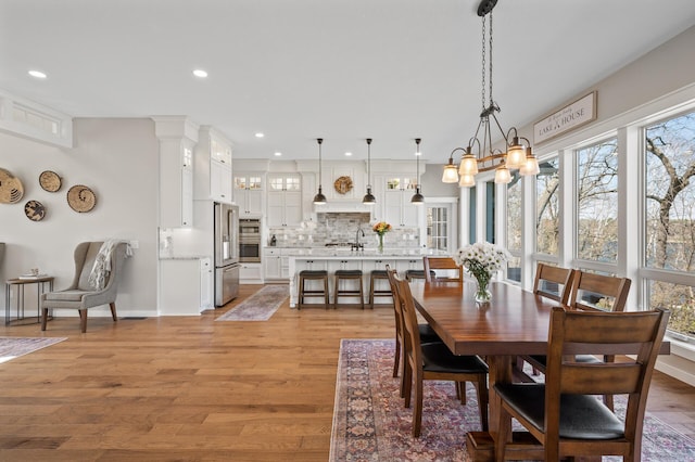 dining space with recessed lighting, baseboards, and light wood-style floors