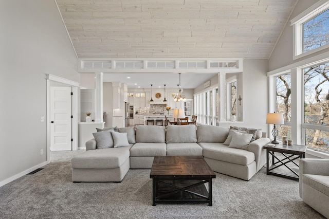 carpeted living area featuring a notable chandelier, high vaulted ceiling, baseboards, visible vents, and wood ceiling