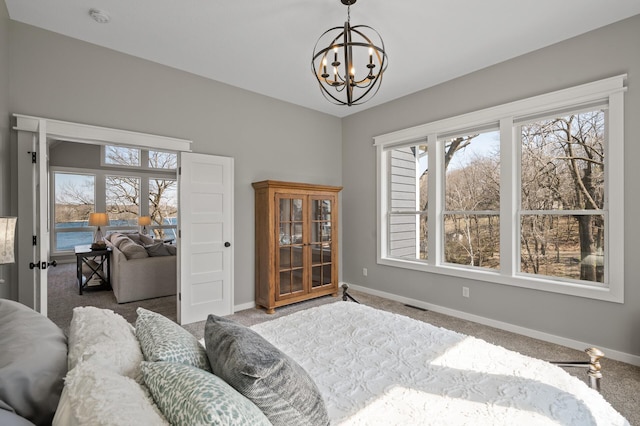 interior space with baseboards, an inviting chandelier, and visible vents