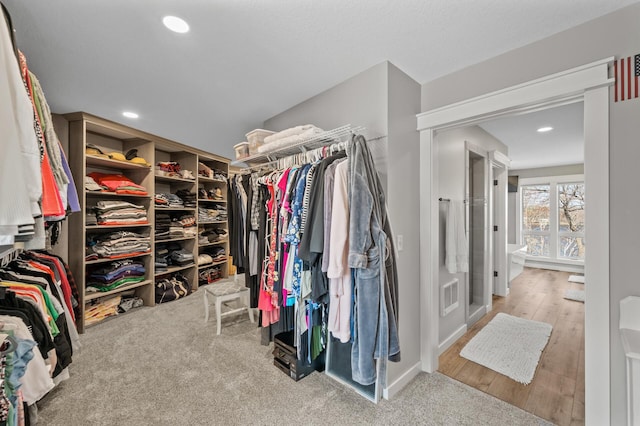 walk in closet featuring visible vents and wood finished floors