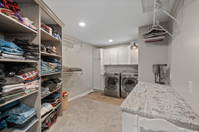 washroom with light colored carpet, washing machine and dryer, cabinet space, baseboards, and recessed lighting