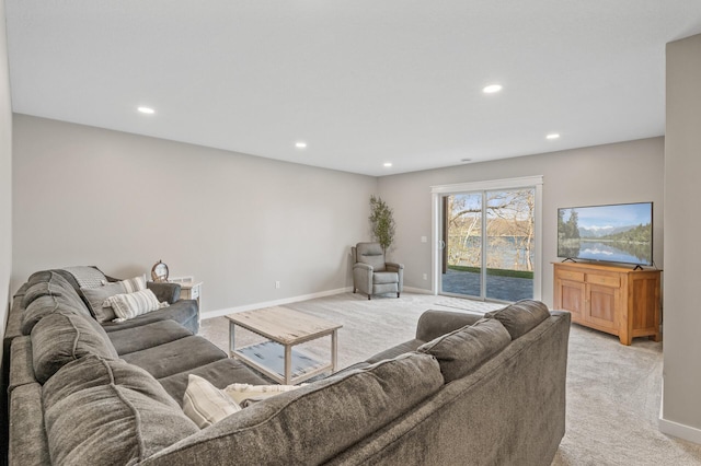 living room with recessed lighting, baseboards, and light carpet
