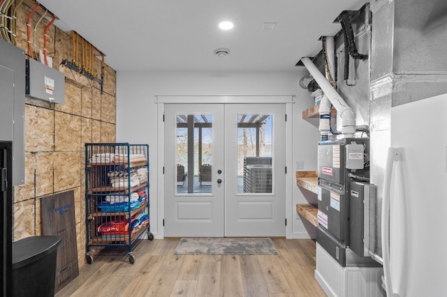 doorway to outside featuring recessed lighting, french doors, and light wood finished floors
