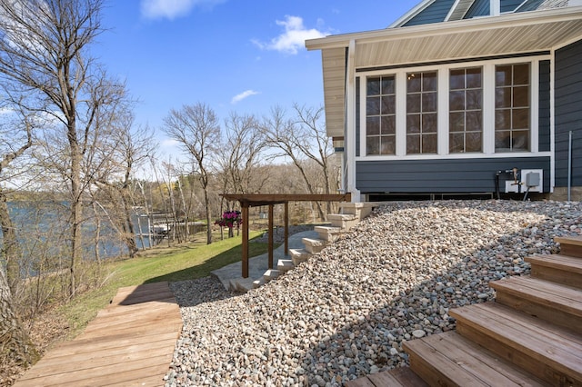 deck featuring a lawn and stairs