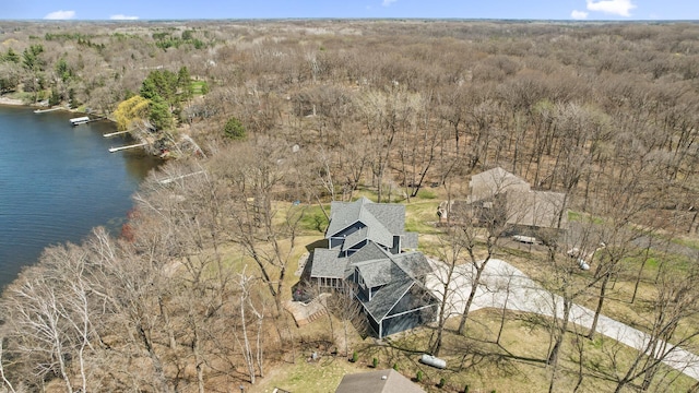 aerial view with a water view and a wooded view