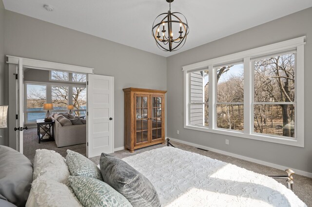9129 279th Ave NW, Zimmerman, MN 55398 - carpeted bedroom featuring a chandelier and baseboards