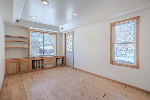 304 3rd Ave, Virginia, MN 55792 - empty room featuring light wood-style floors, recessed lighting, baseboards, and a tray ceiling