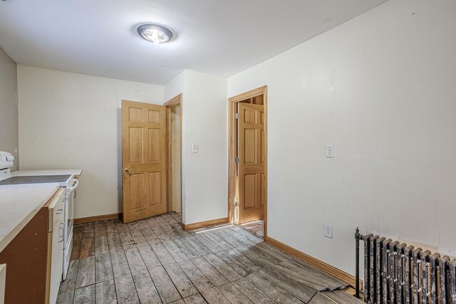 304 3rd Ave, Virginia, MN 55792 - laundry area featuring baseboards, radiator, and light wood-style floors