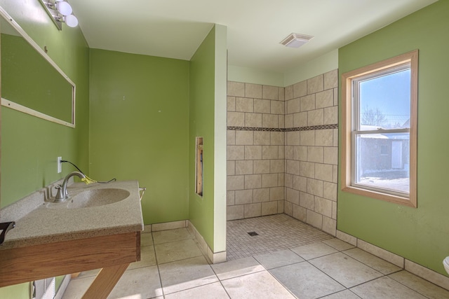 304 3rd Ave, Virginia, MN 55792 - bathroom with vanity, tile patterned floors, baseboards, visible vents, and tiled shower
