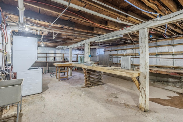 304 3rd Ave, Virginia, MN 55792 - unfinished basement featuring stacked washing maching and dryer, a workshop area, and a sink
