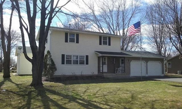 traditional-style house with aphalt driveway, a garage, a porch, a front yard, and central AC unit