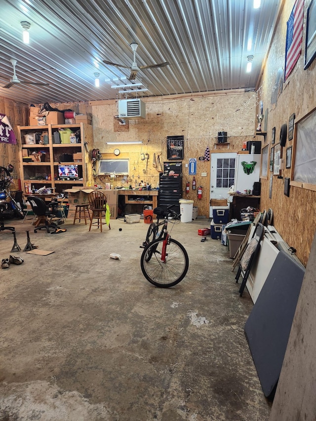garage with a ceiling fan and a workshop area