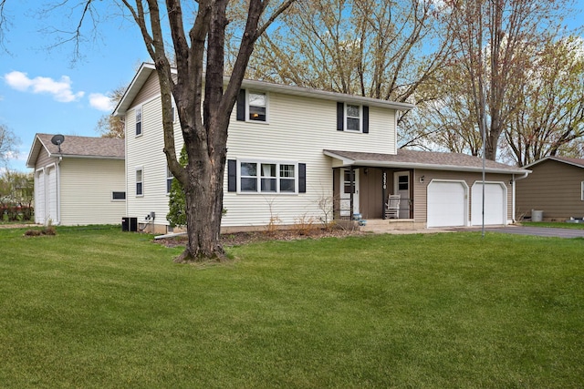 traditional-style home with a garage, cooling unit, driveway, and a front lawn