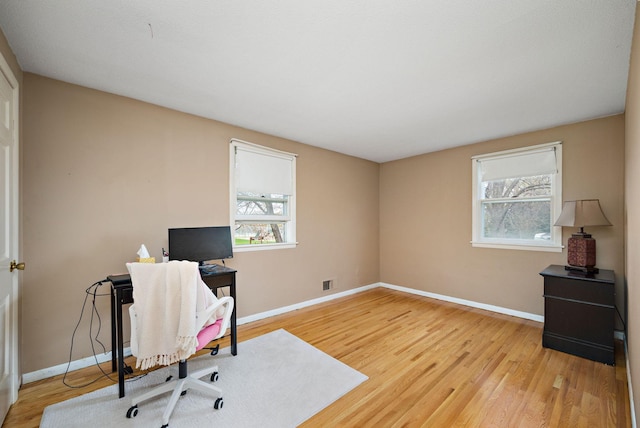 office area featuring plenty of natural light, light wood-style flooring, and baseboards