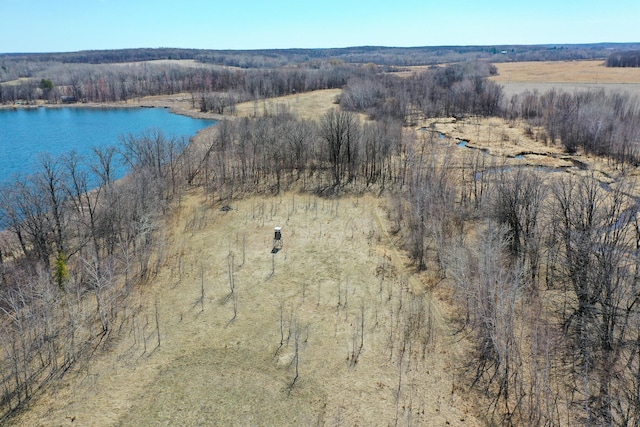 aerial view featuring a forest view and a water view