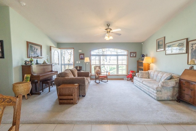carpeted living room featuring ceiling fan and lofted ceiling