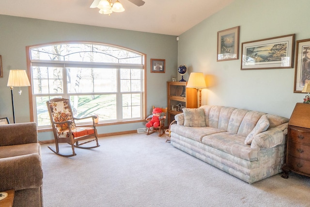 living area featuring lofted ceiling, visible vents, ceiling fan, and carpet floors
