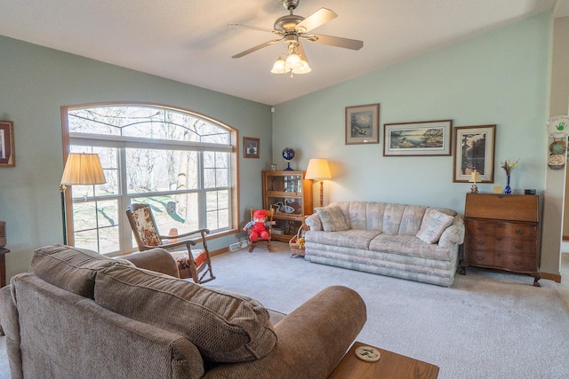 living area featuring carpet, a ceiling fan, visible vents, baseboards, and lofted ceiling