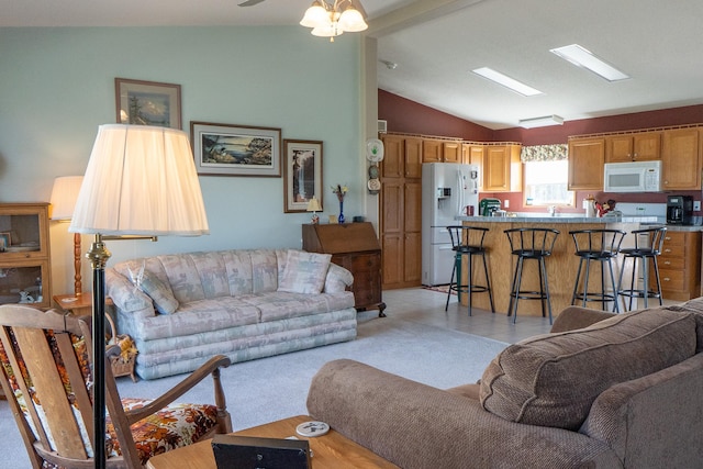 living room featuring vaulted ceiling and a ceiling fan