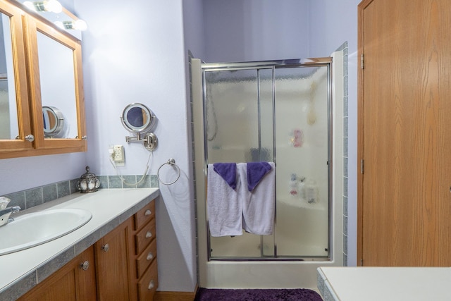 bathroom featuring a shower stall and vanity