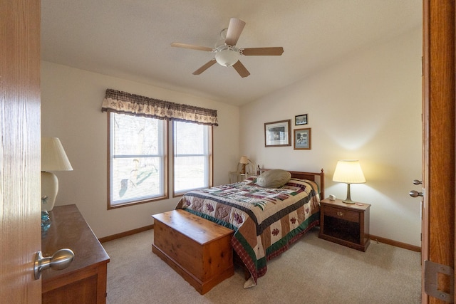 bedroom with lofted ceiling, baseboards, ceiling fan, and light colored carpet
