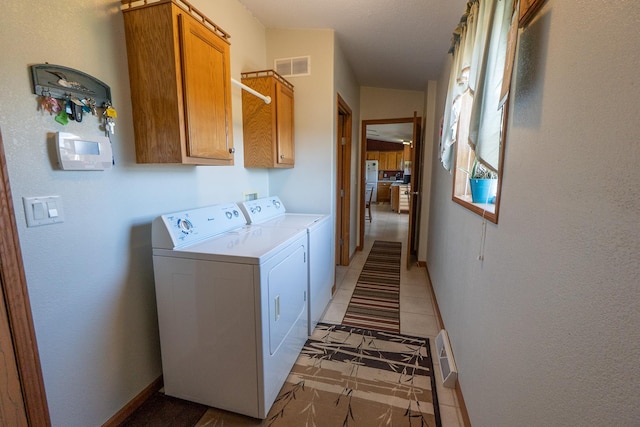 laundry room with independent washer and dryer, cabinet space, baseboards, and visible vents
