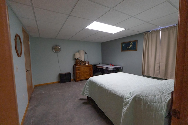bedroom with baseboards, a paneled ceiling, and carpet