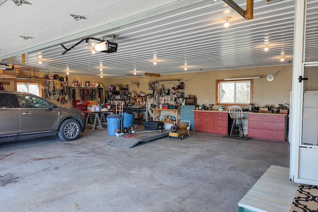 garage with a workshop area and a garage door opener