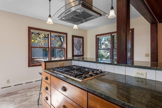 kitchen with gas stovetop, wall chimney exhaust hood, a baseboard heating unit, and decorative light fixtures