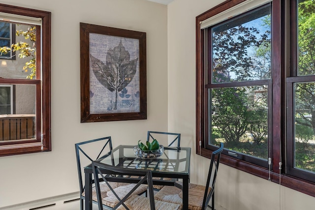 dining space with a baseboard heating unit and plenty of natural light