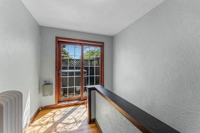 property entrance with radiator and a balcony