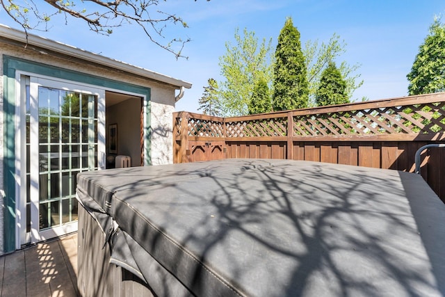deck with a hot tub