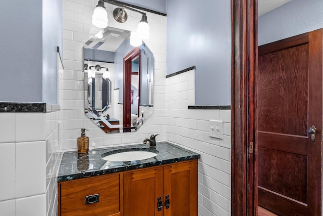 bathroom featuring decorative backsplash, vanity, and tile walls
