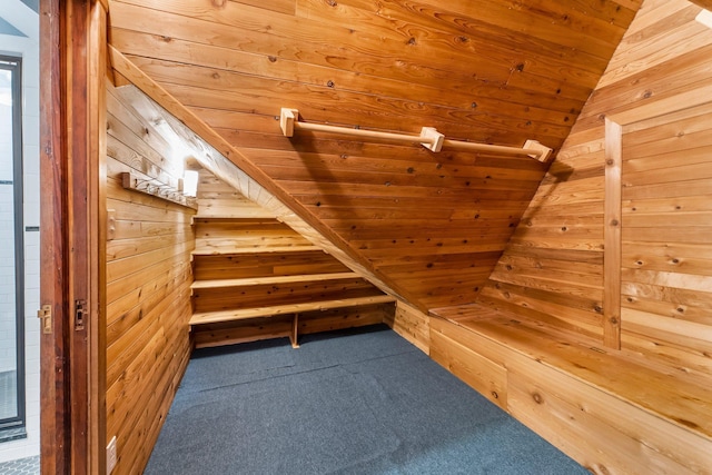 additional living space featuring wood walls, wooden ceiling, carpet, a sauna, and vaulted ceiling