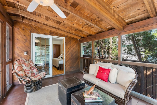 sunroom featuring beamed ceiling, a ceiling fan, and an outdoor hangout area